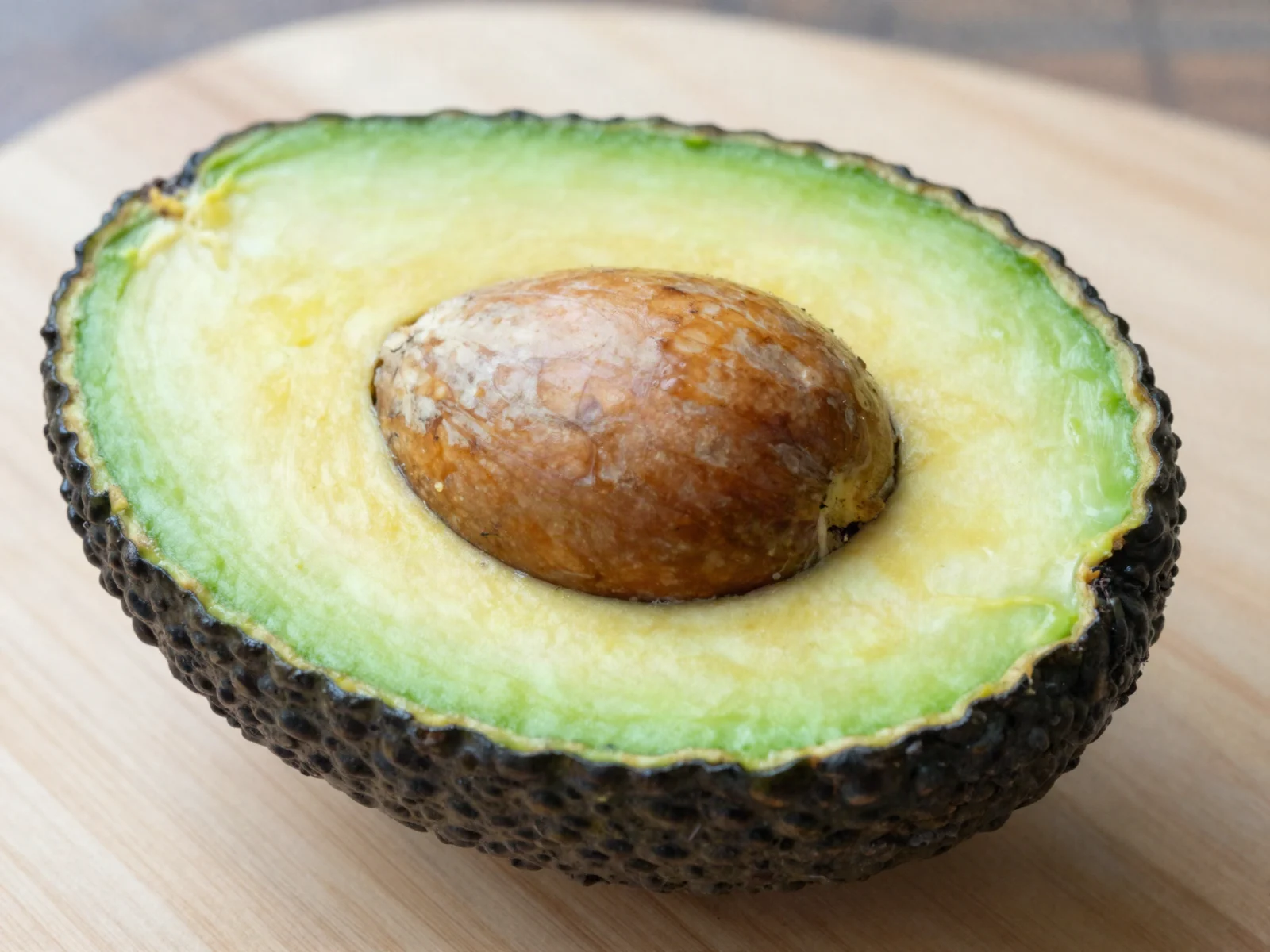 Ripe avocados are ready when the flesh looks like this: light green and buttery, with the pit in place