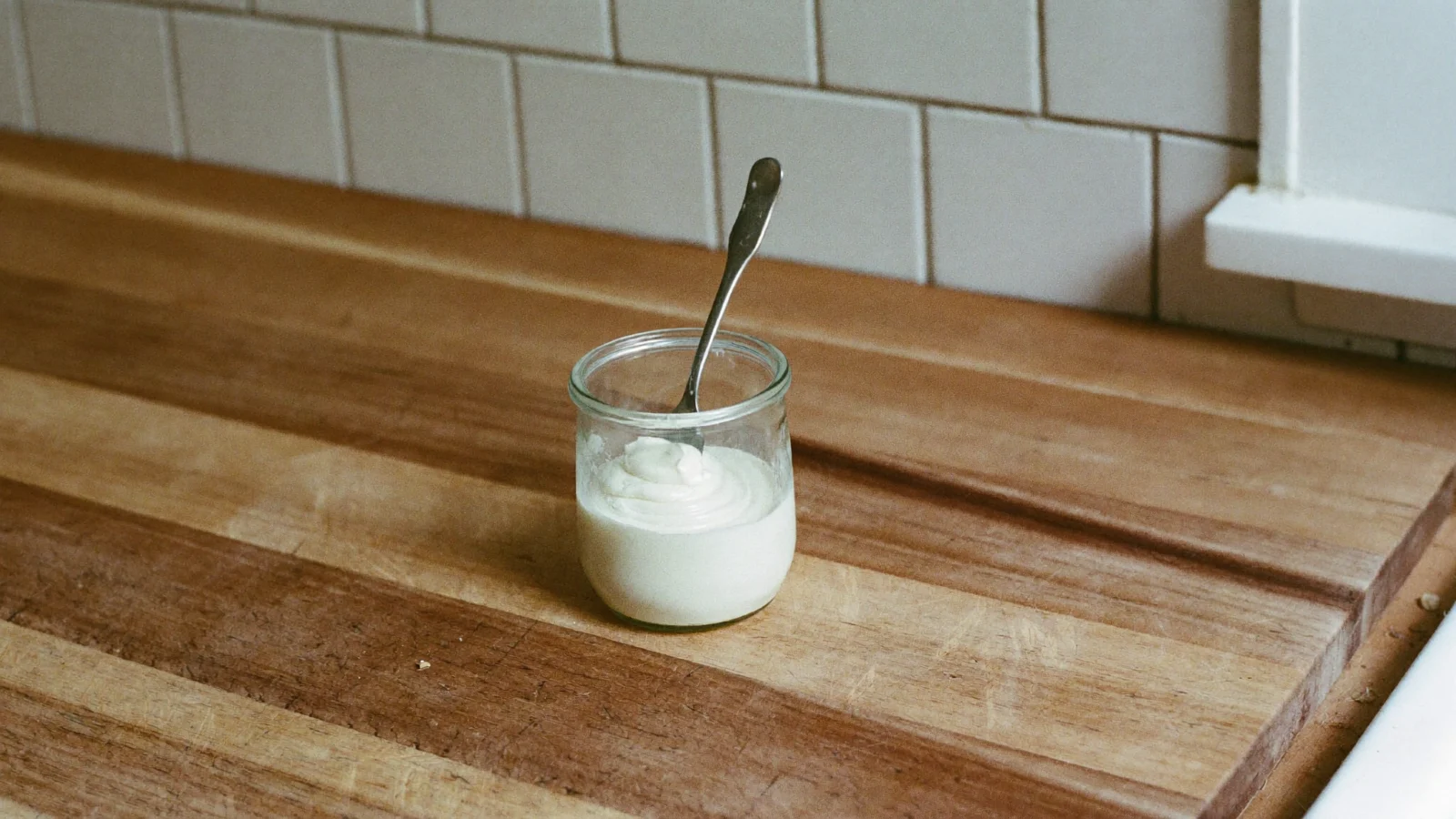 Fresh bacon grease, creamy white and smooth in an open jar
