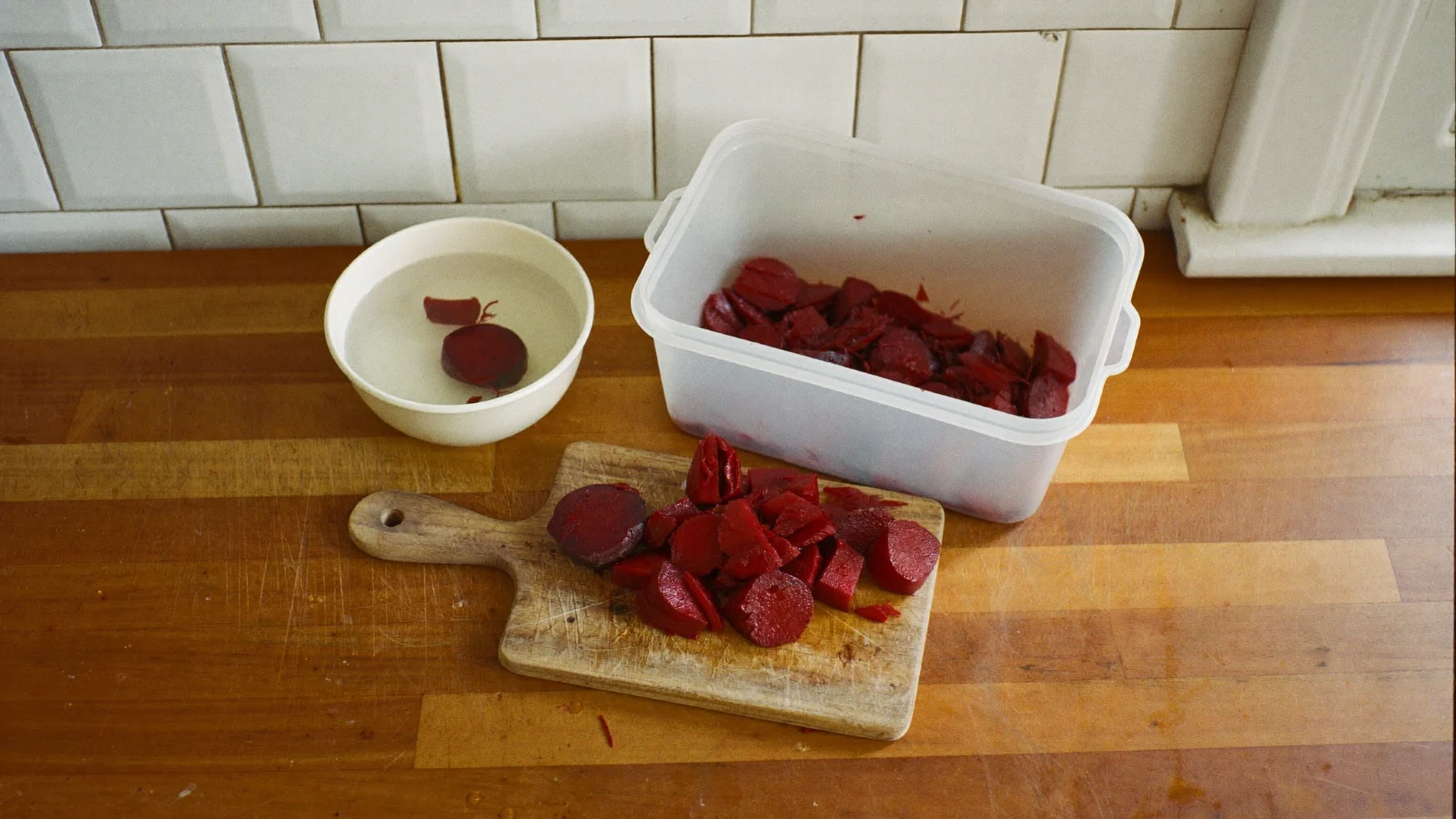 Cooked, peeled beet slices being packed into a freezer container