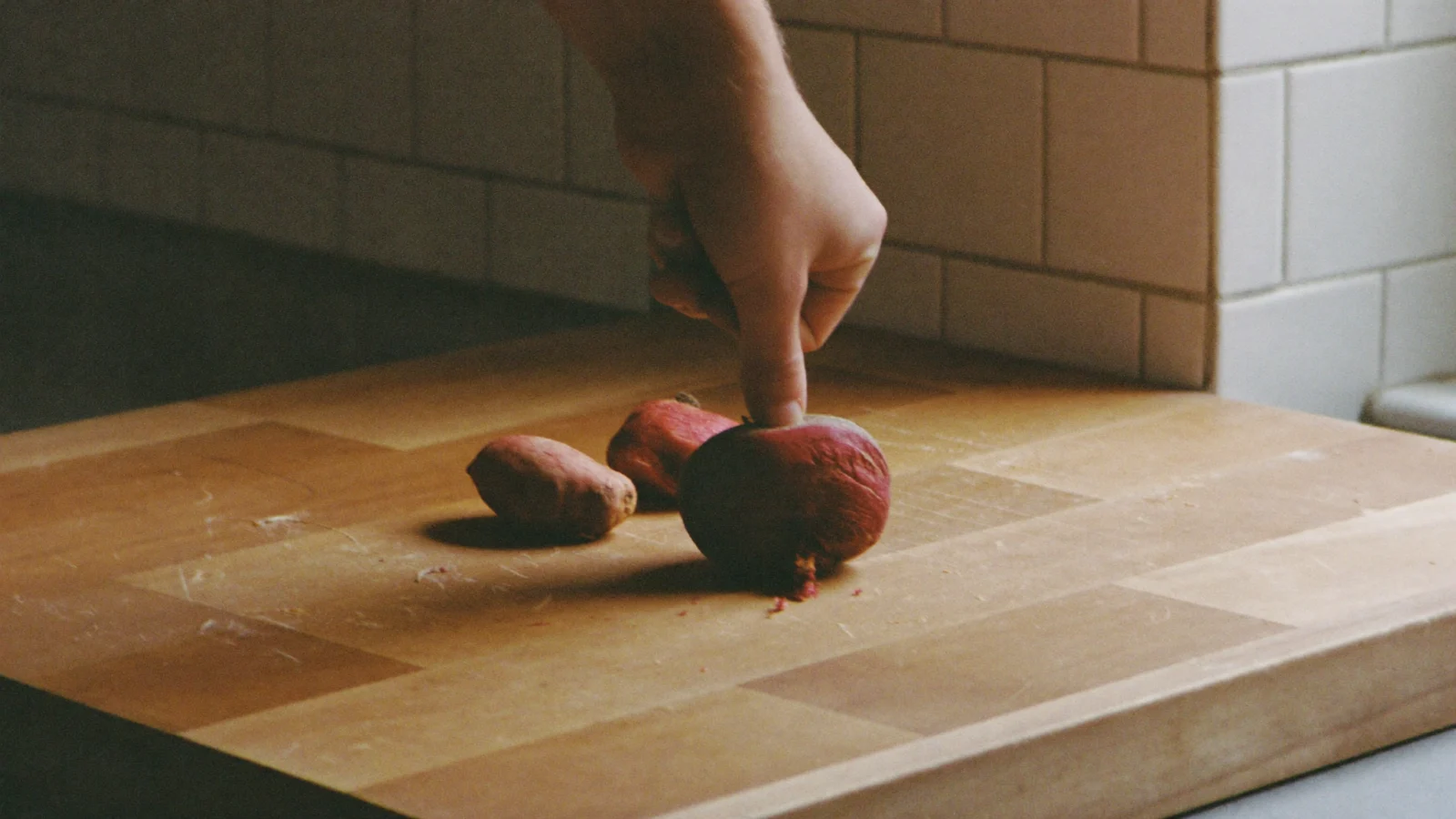 A soft beet with wrinkled skin bending slightly when squeezed