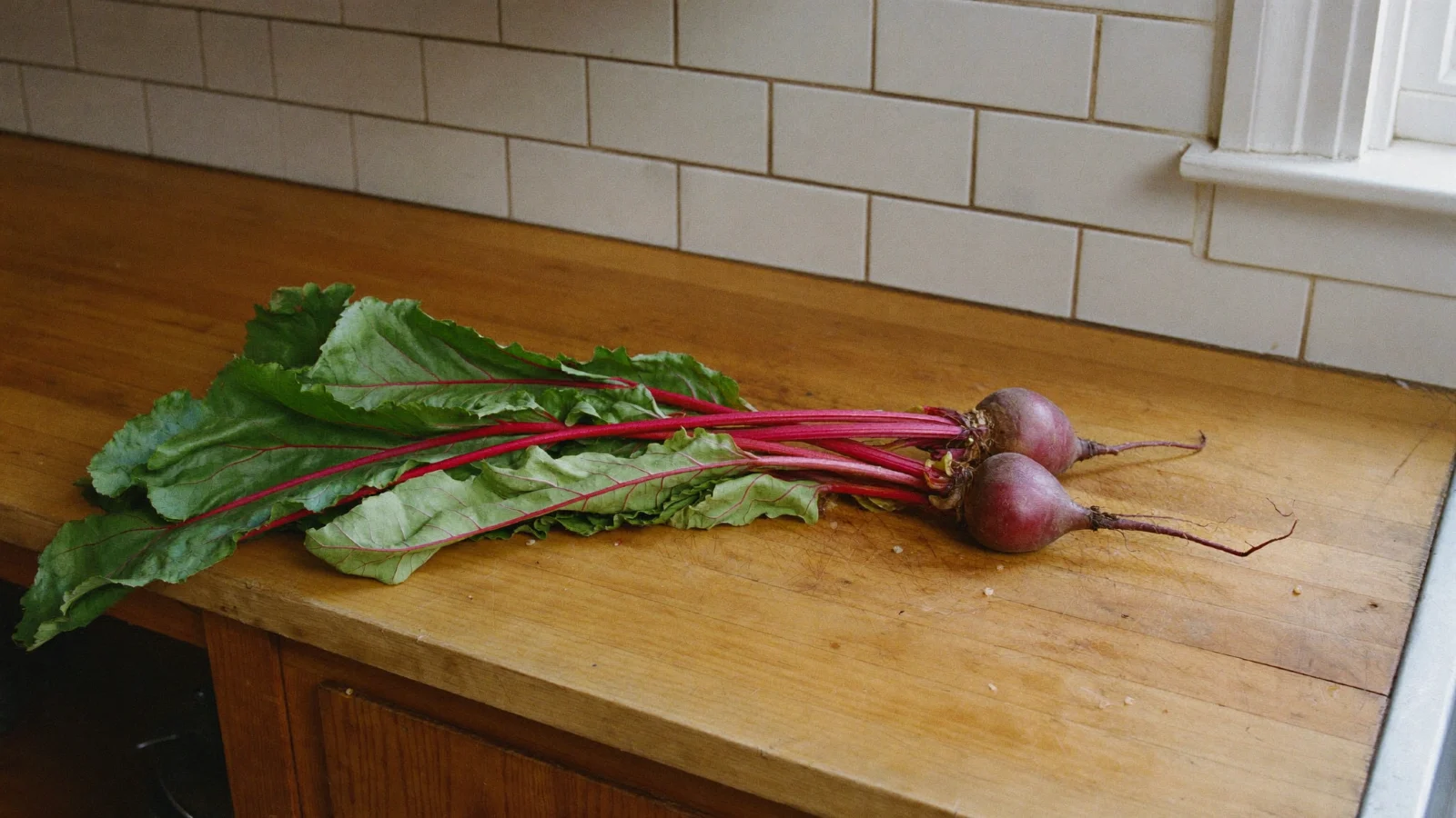A bunch of beets whose leafy greens have gone limp