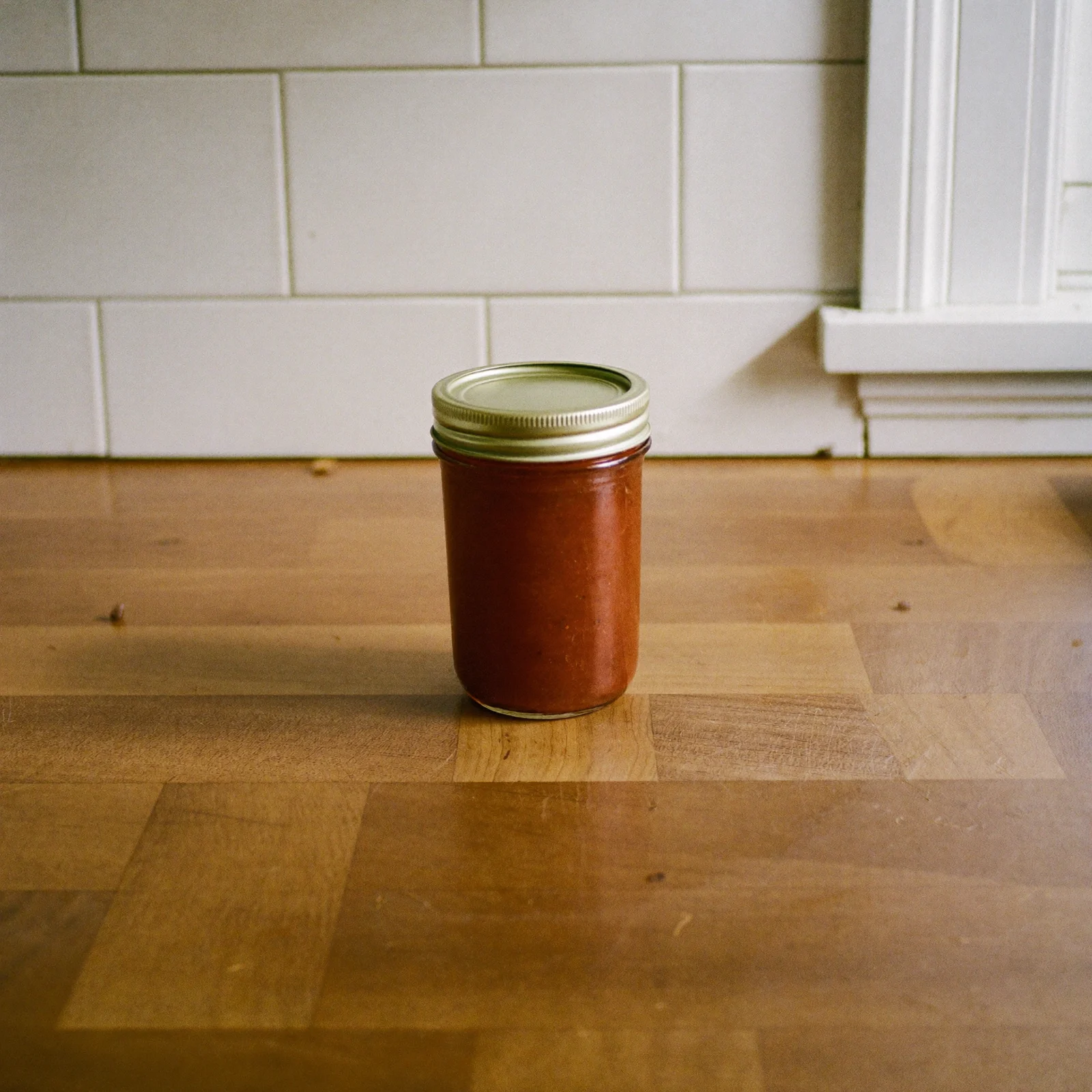 A sealed jar of cocktail sauce: check that the lid is flat, not domed, before opening