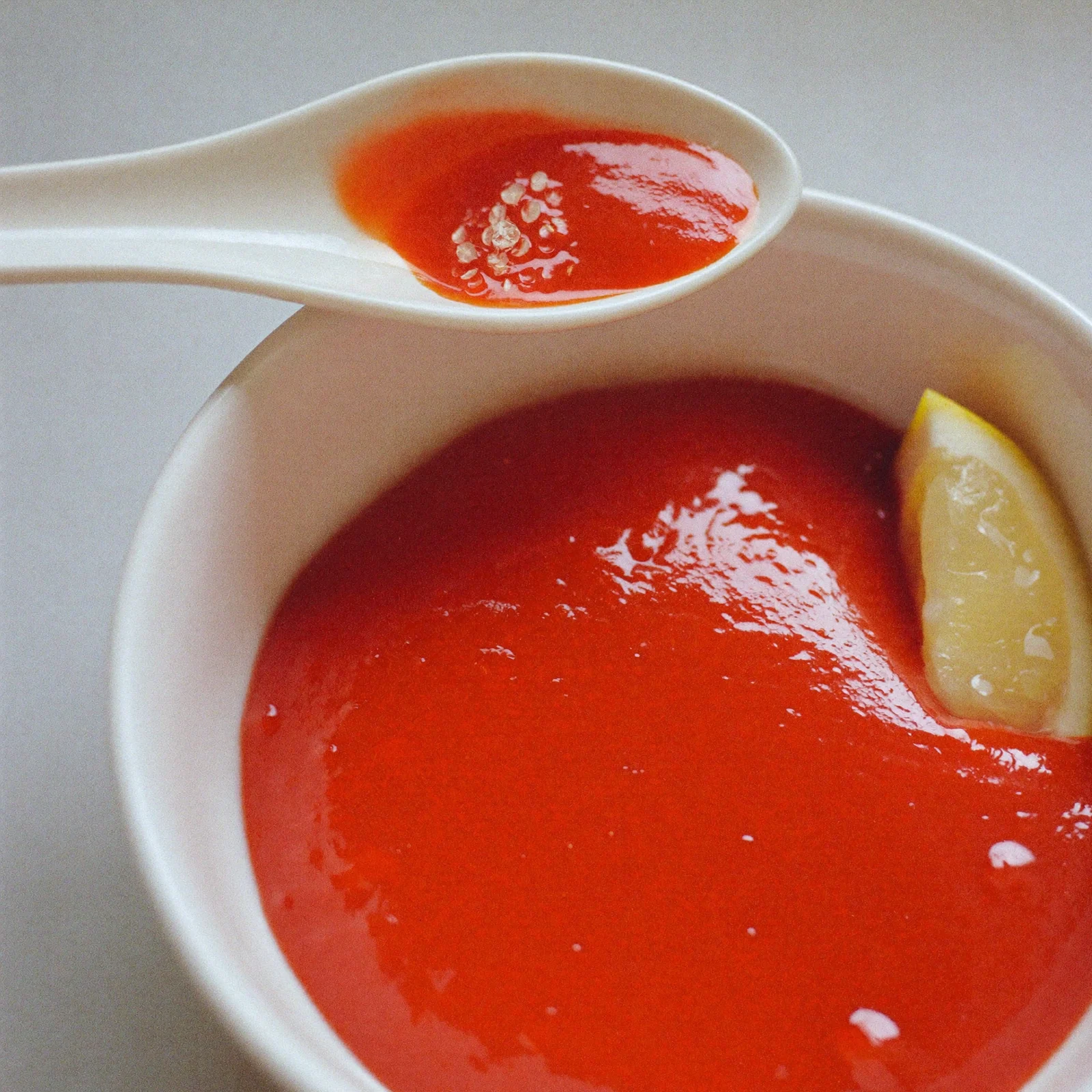 Fresh, bright red cocktail sauce in a bowl with a spoon