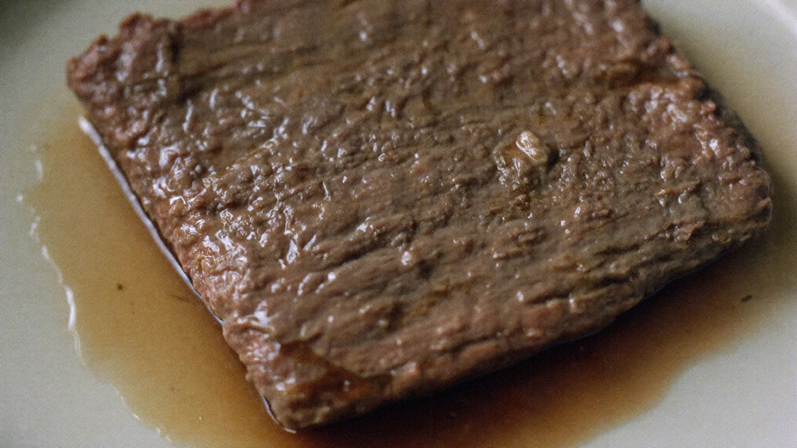 Spoiled ground beef with a slick, sticky-looking surface
