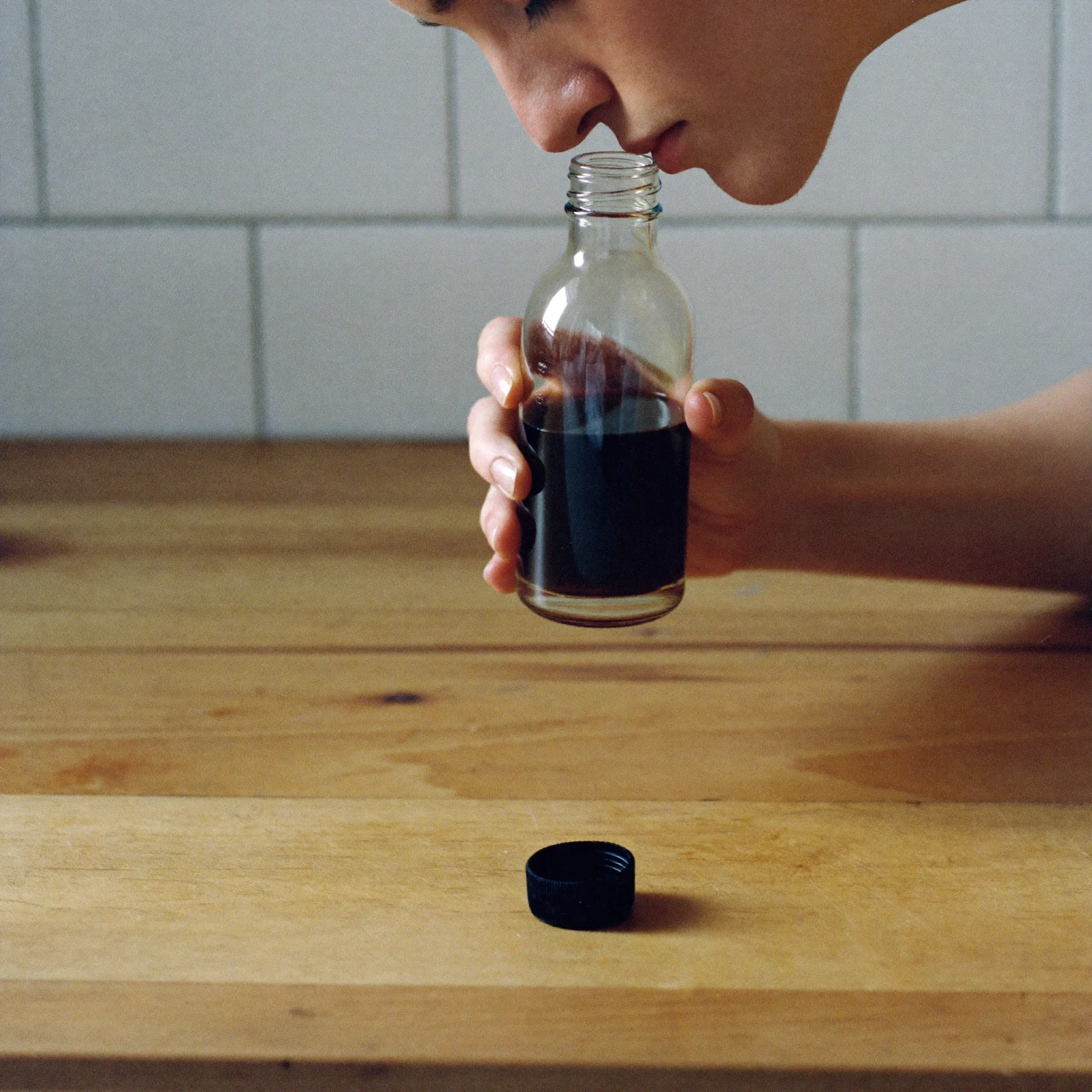 Smelling an open bottle of imitation vanilla that has turned