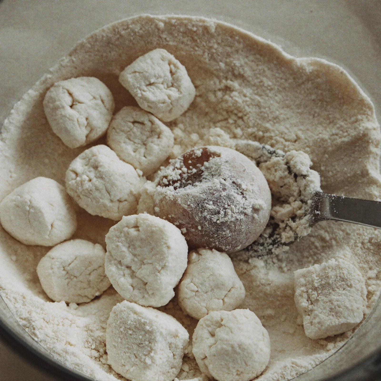 Hard, caked clumps of damp self-rising flour in an open canister