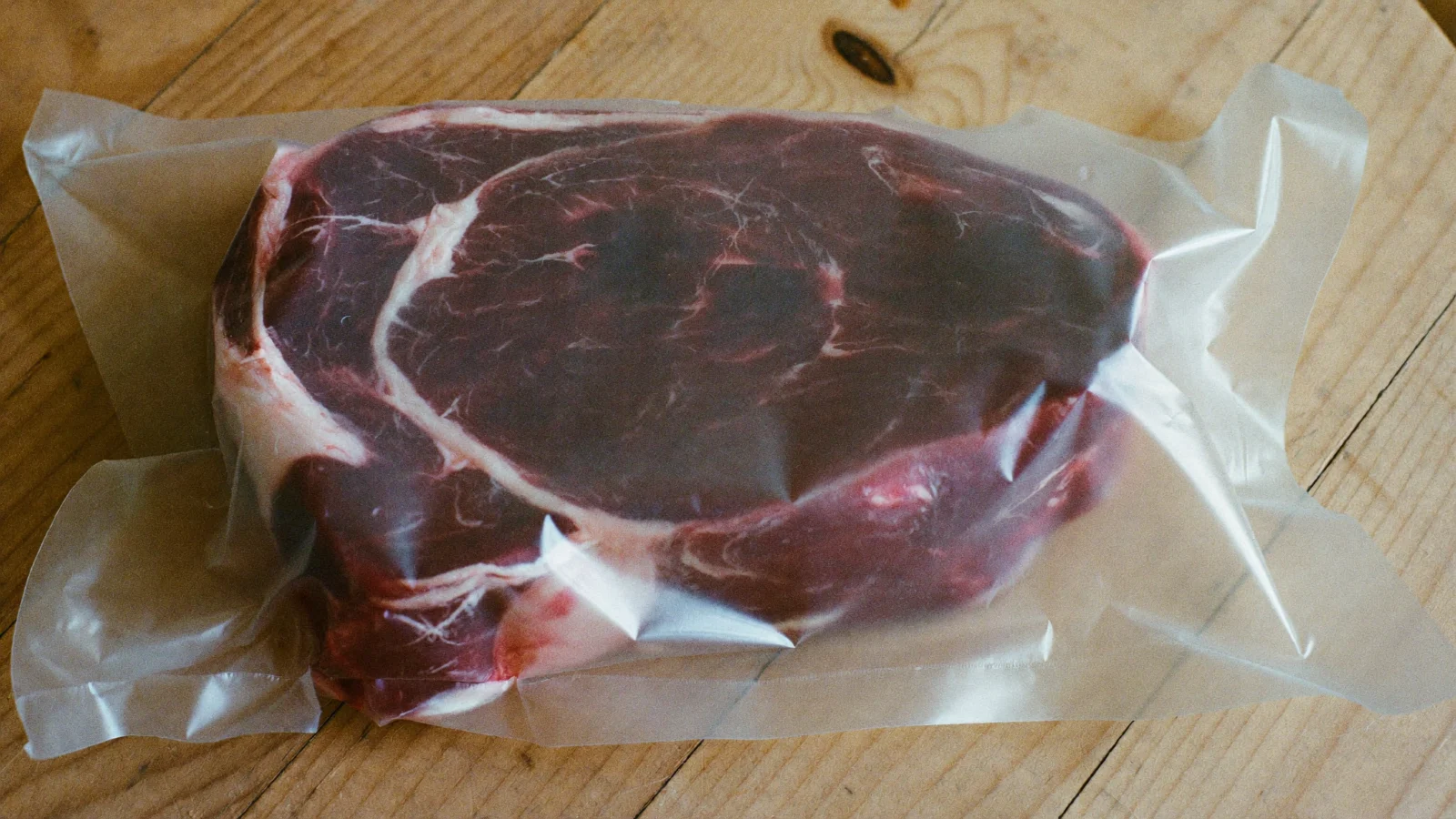 A vacuum-packed steak with a dark purple color