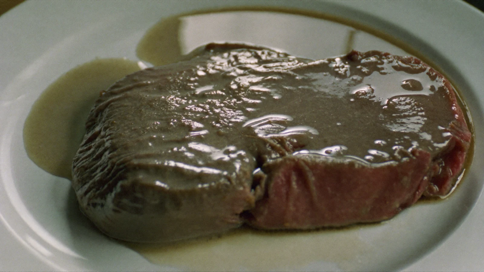 A spoiled steak with a dull, slick, sticky-looking surface