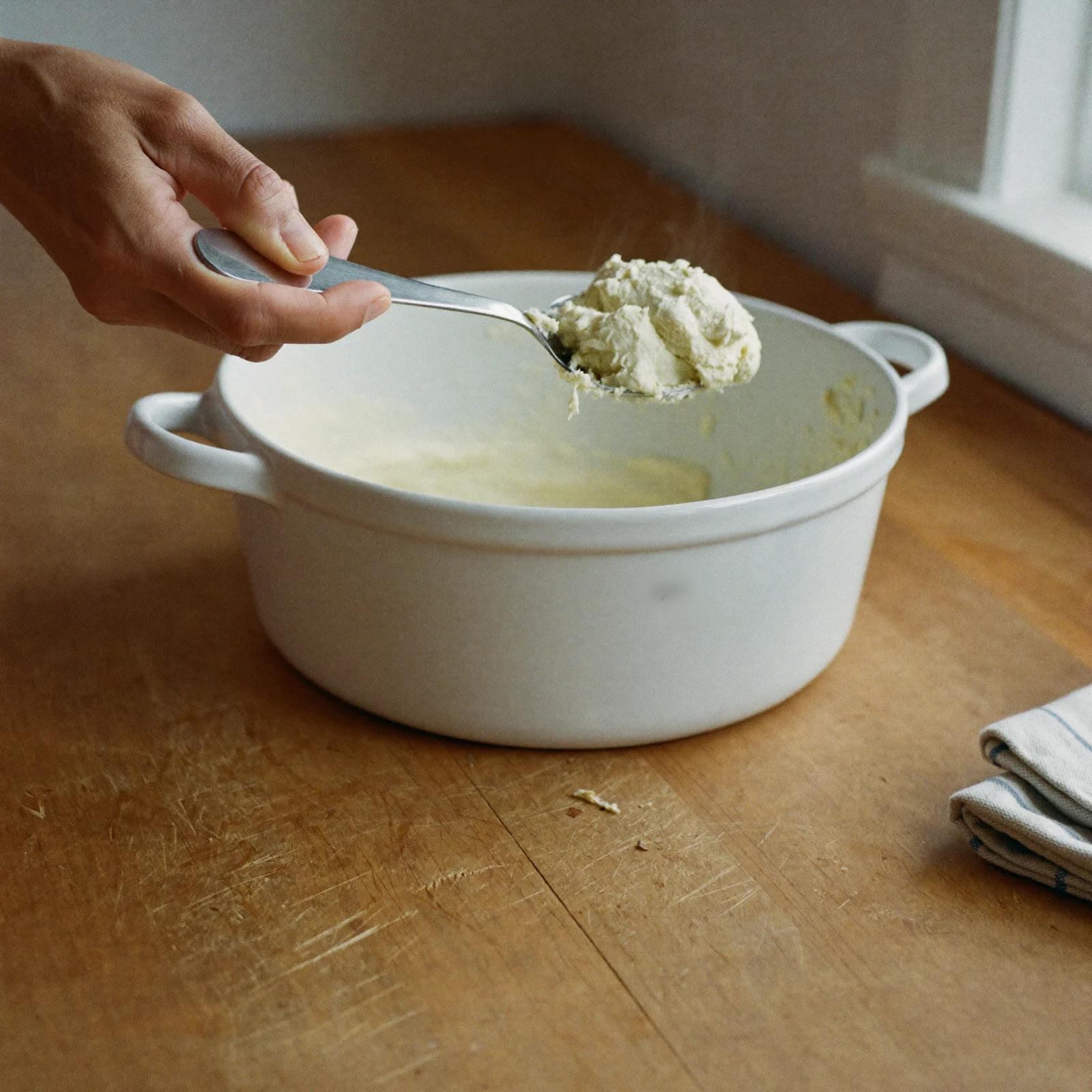 Scooping vegetable shortening with a clean, dry spoon
